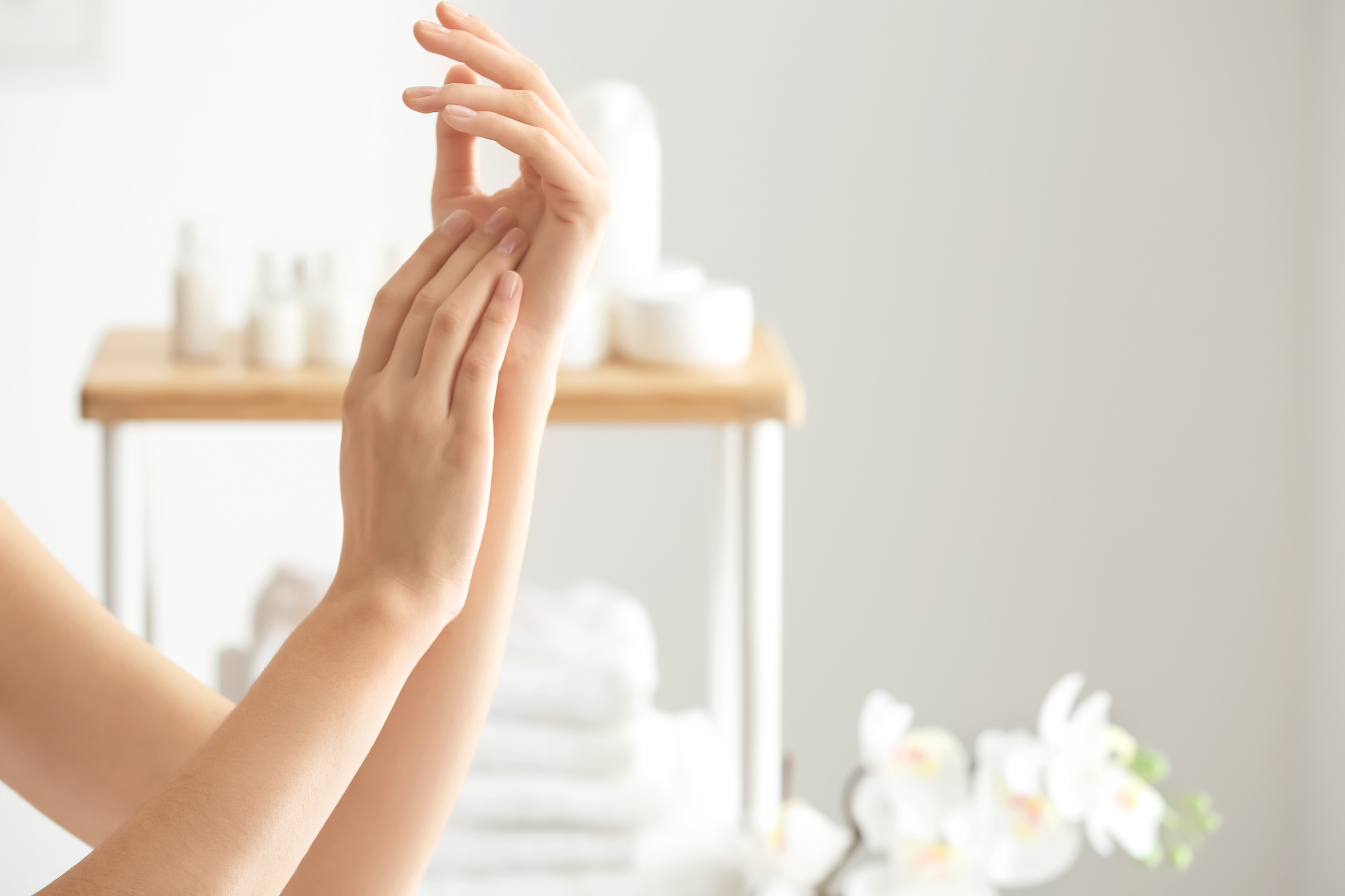 Young Woman Applying Hand Cream 